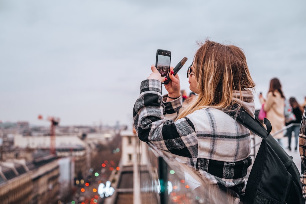 a woman taking a picture with her cell phone