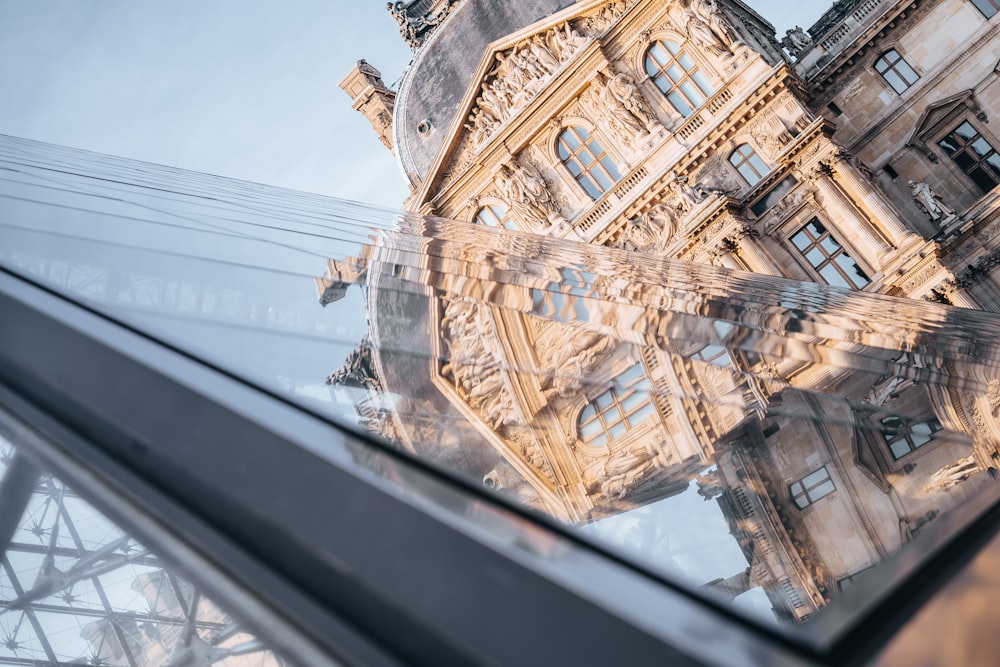 a reflection of a building in a window