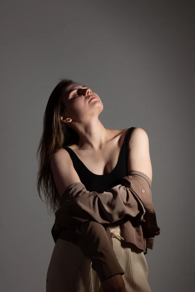 a woman with her arms crossed and her eyes closed