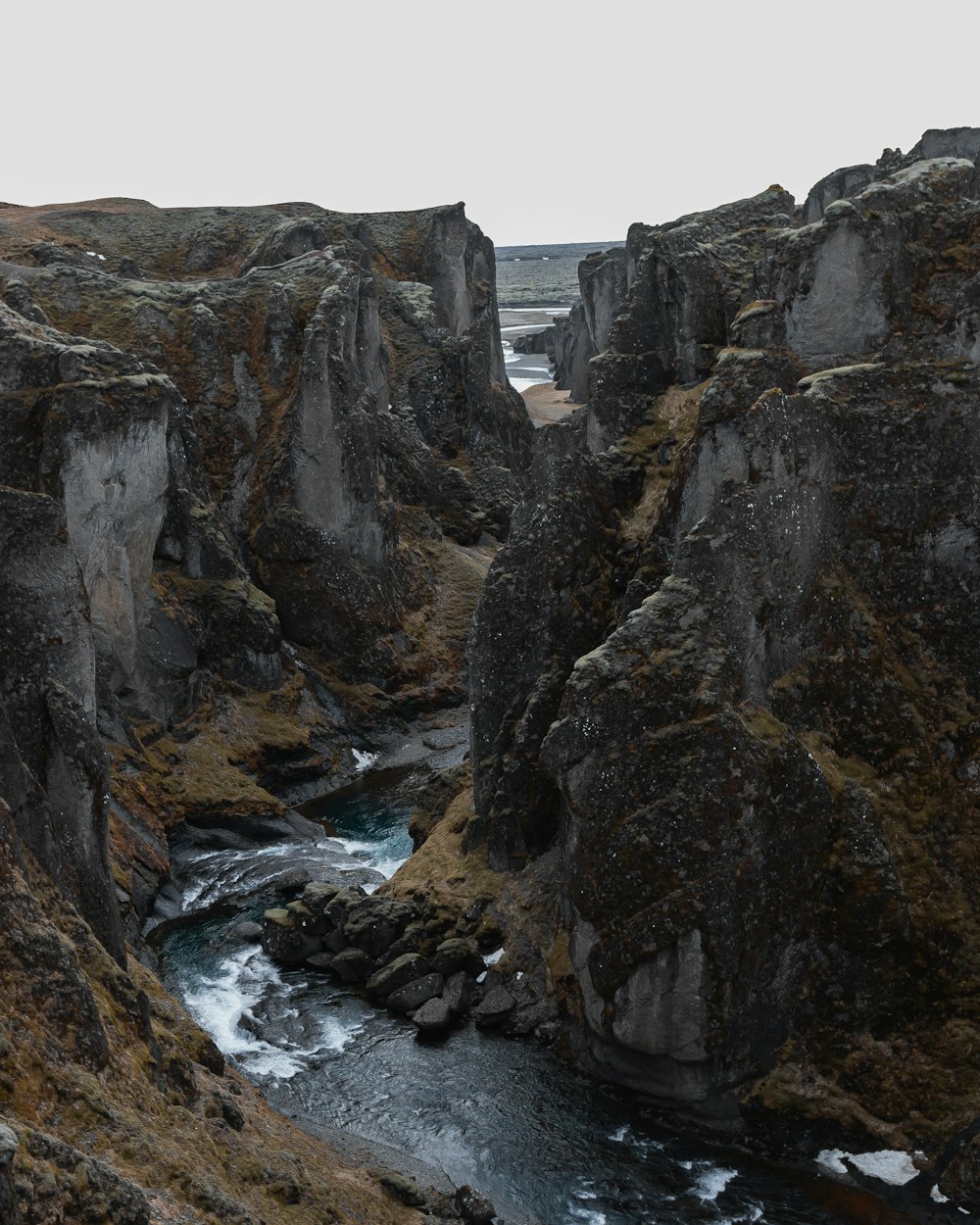 a river flowing between two large rocks
