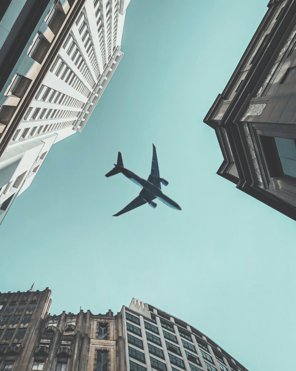 an airplane flying in the sky over a city