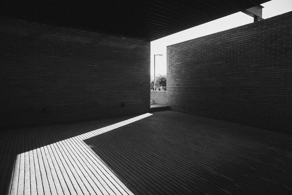 a black and white photo of a sunlit room