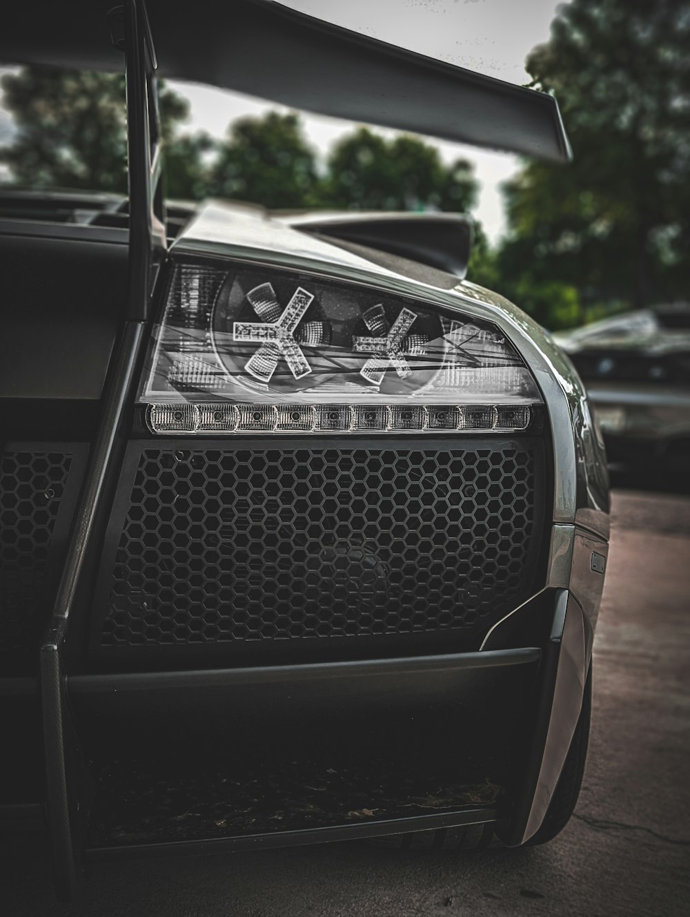 a black sports car parked in a parking lot