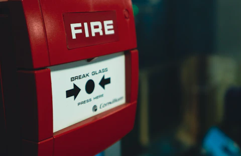 a close up of a red fire alarm