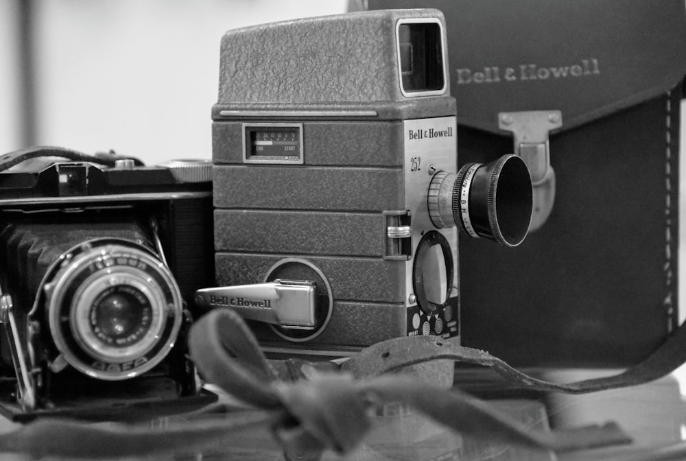 a black and white photo of an old camera