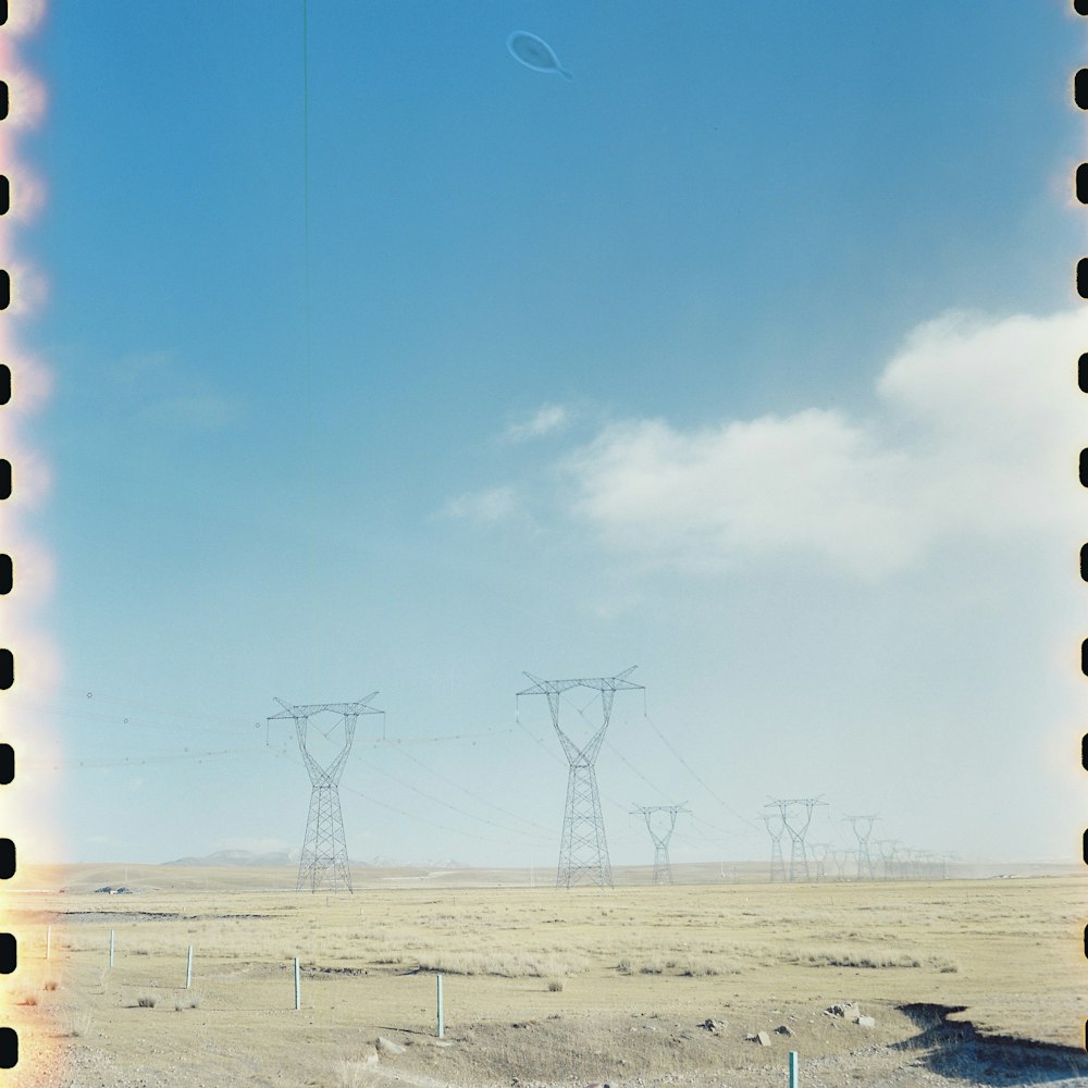 a polaroid photo of power lines in the desert