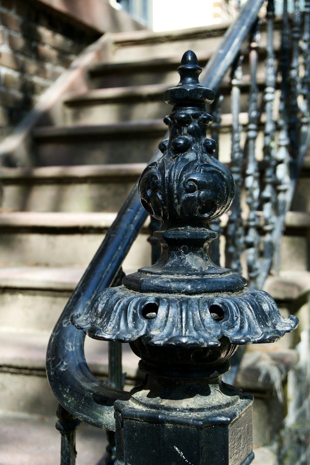 a wrought iron railing on a staircase in a city
