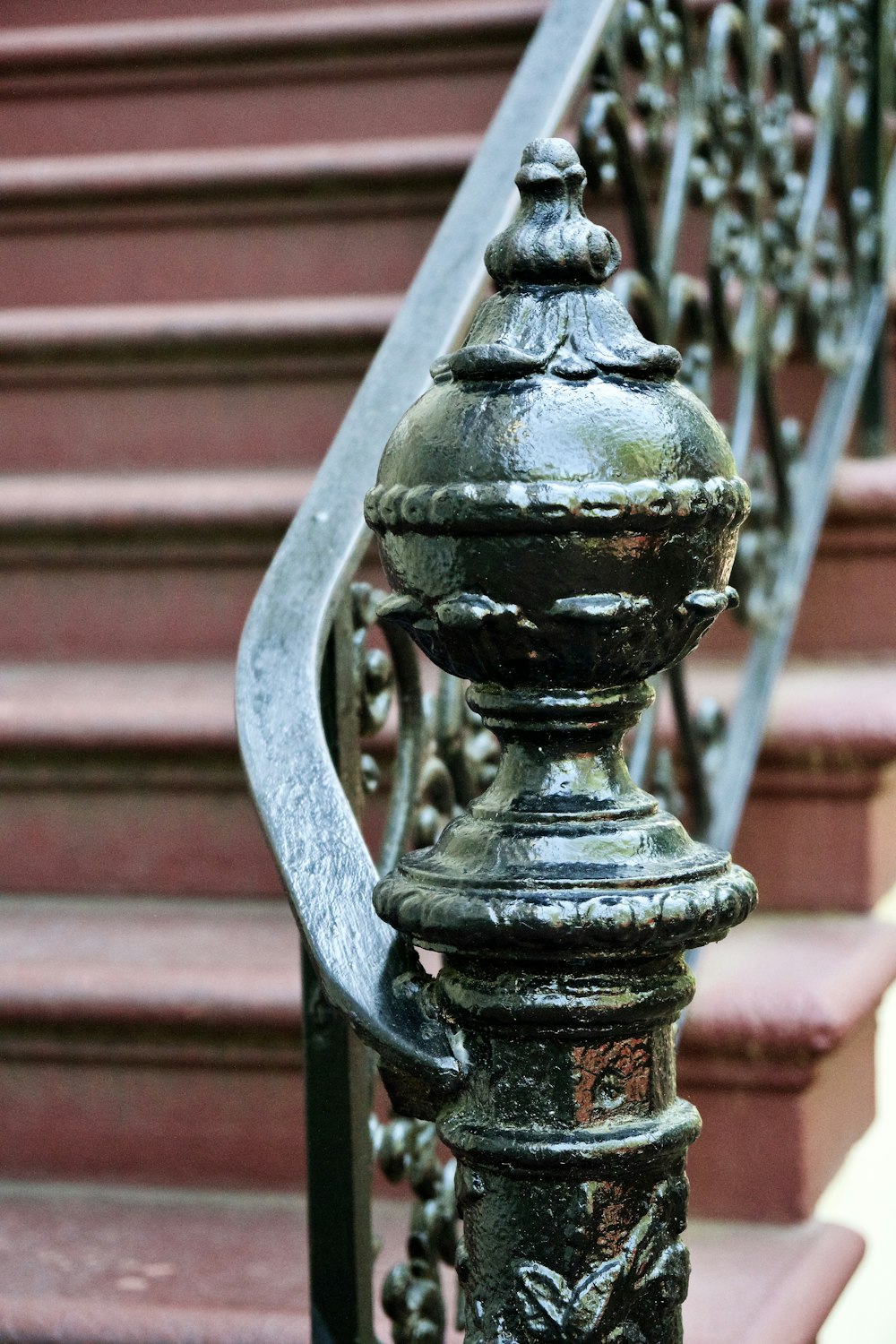 a close up of a metal railing near a set of stairs