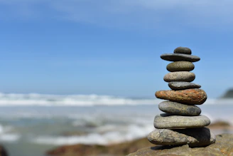 a stack of rocks sitting on top of a beach