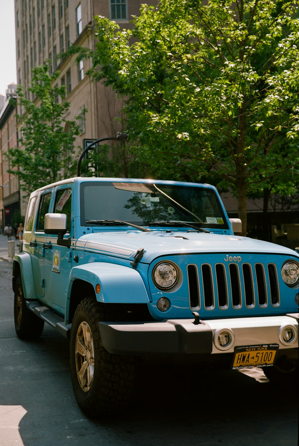 a blue jeep parked on the side of the road