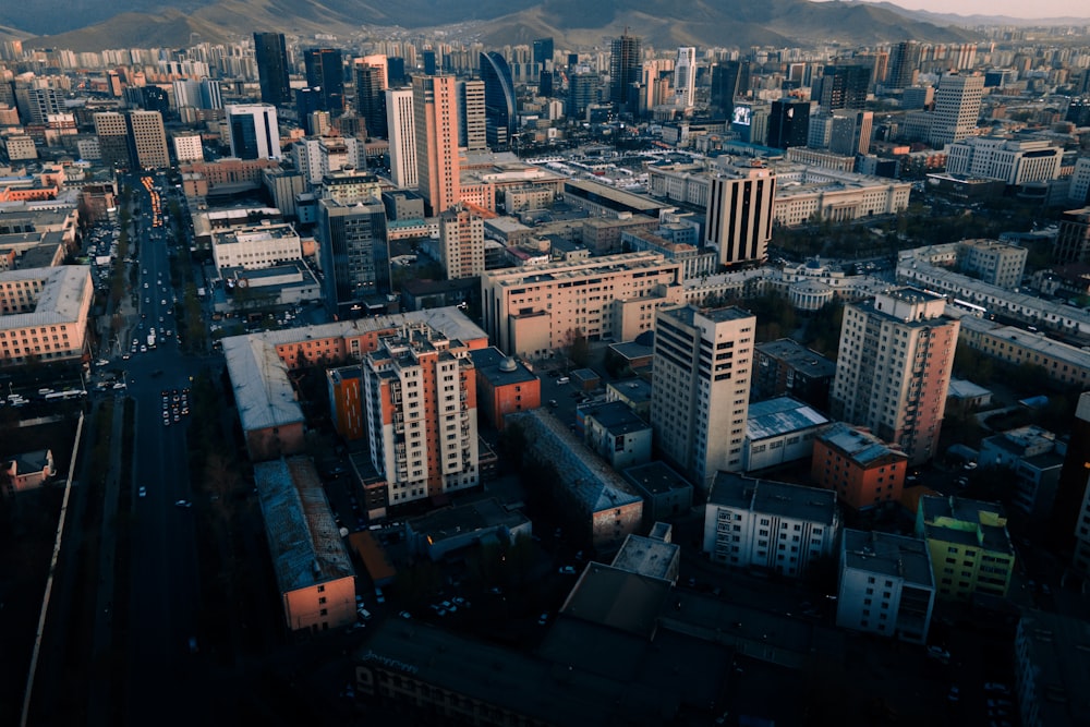 an aerial view of a city with mountains in the background