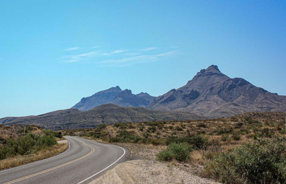 a road with a mountain in the background