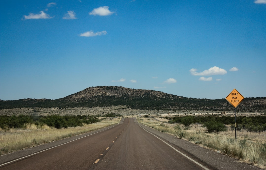 a yellow sign sitting on the side of a road,