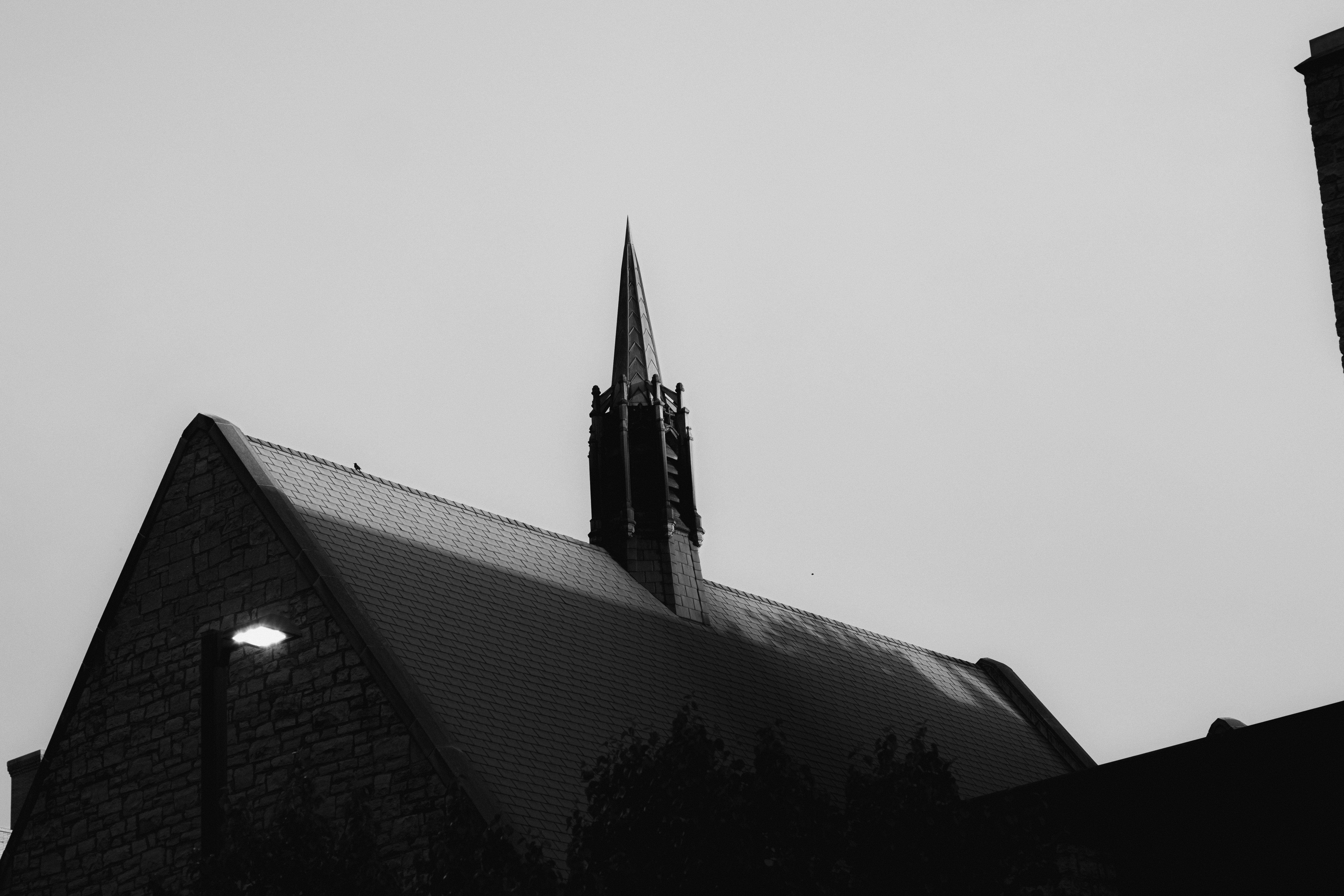 a black and white photo of a church steeple