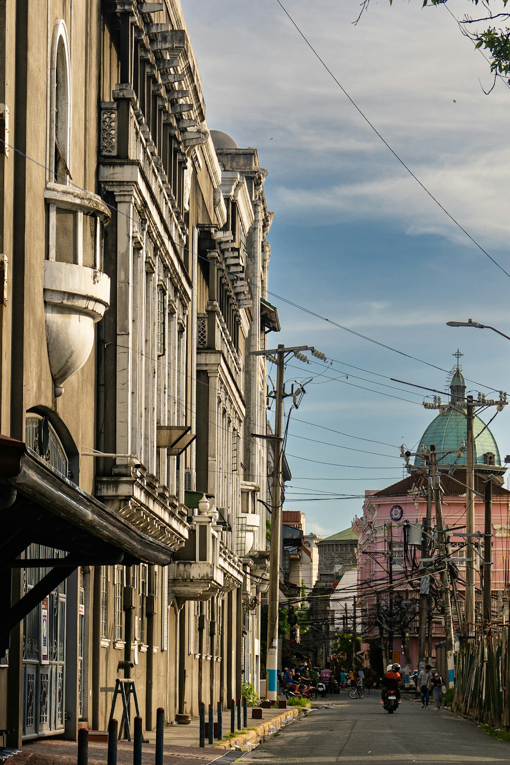 a city street lined with tall buildings and power lines