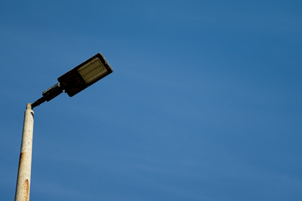 a street light with a blue sky in the background