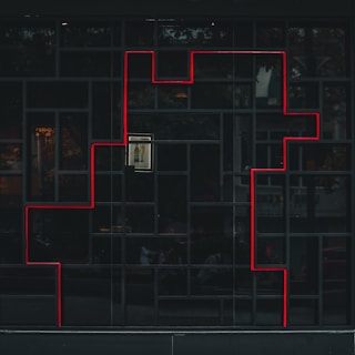 a black building with a red line on the side of it