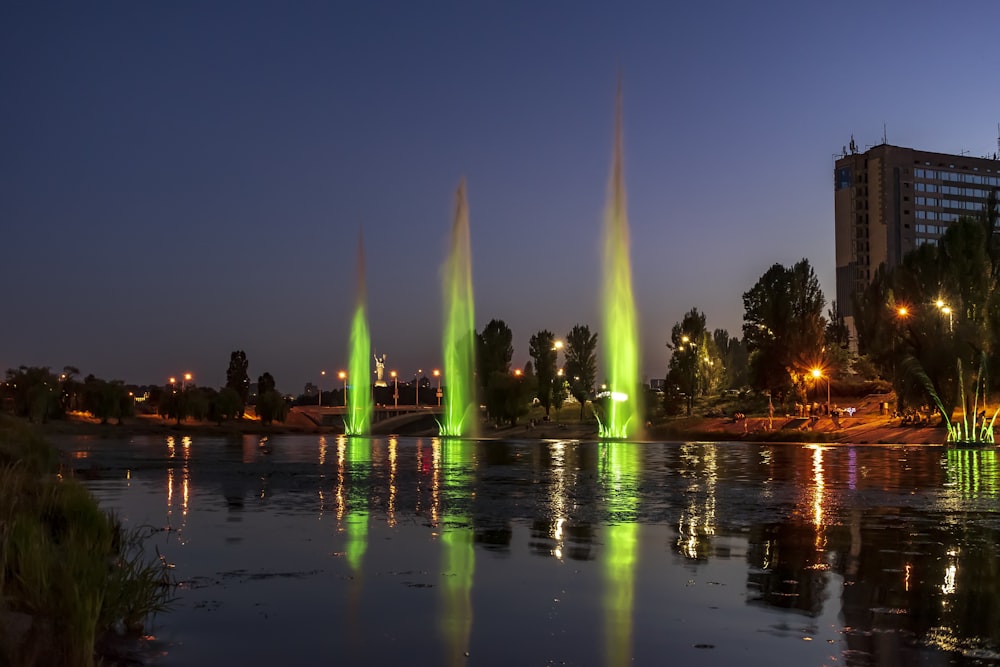 a lake filled with lots of green and yellow fountains