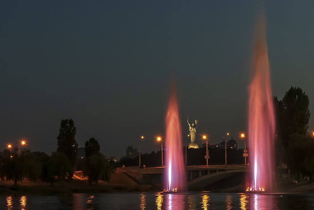 a large fountain of water with a statue in the background