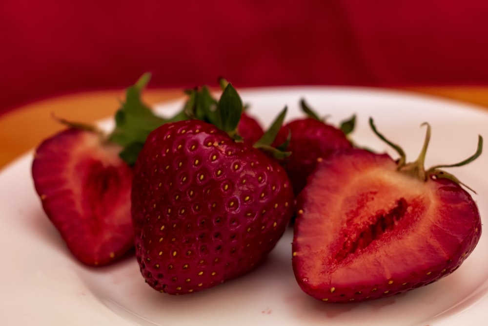 two strawberries on a plate on a table