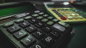 a calculator sitting on top of a table next to another calculator