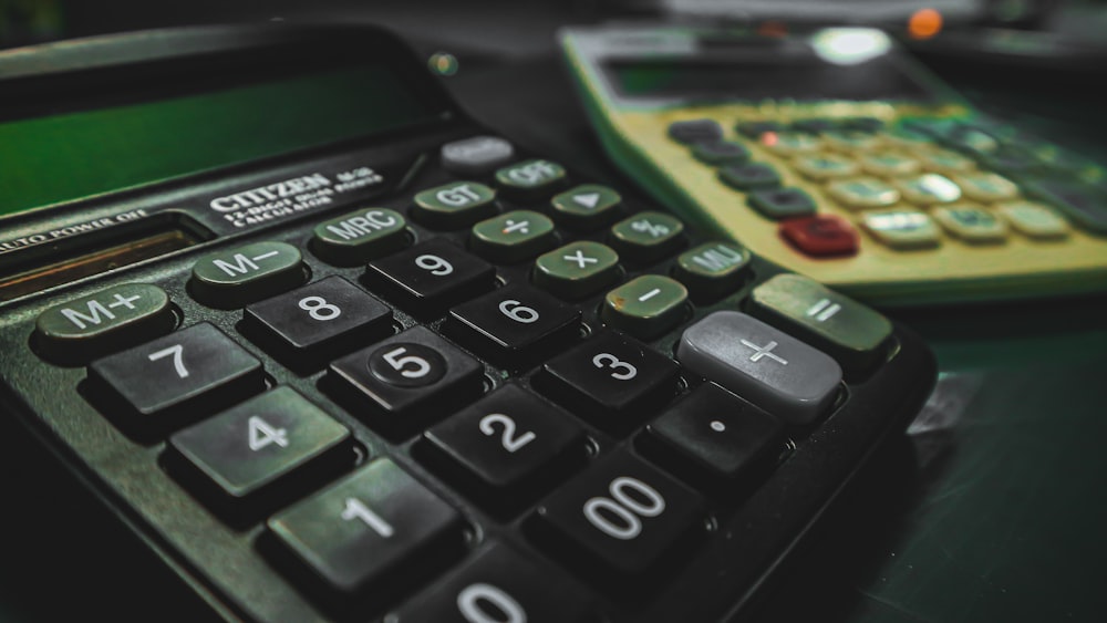 a calculator sitting on top of a table next to another calculator