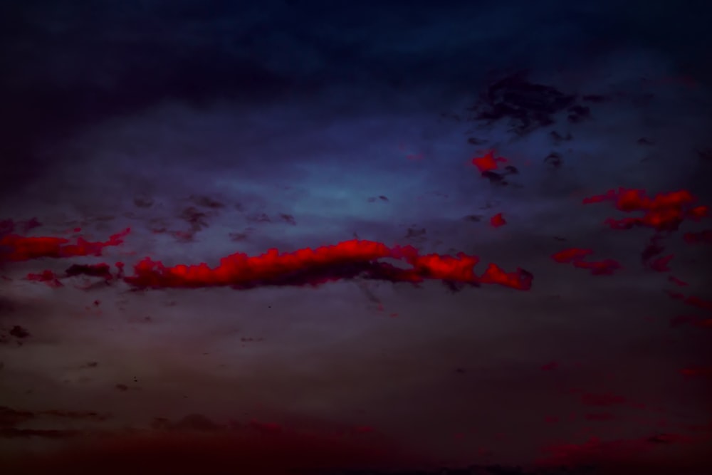 a red and blue sky with some clouds