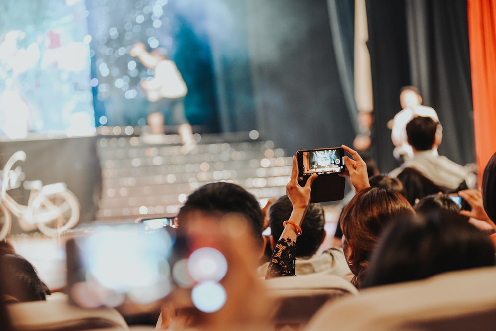 a group of people taking pictures of a stage