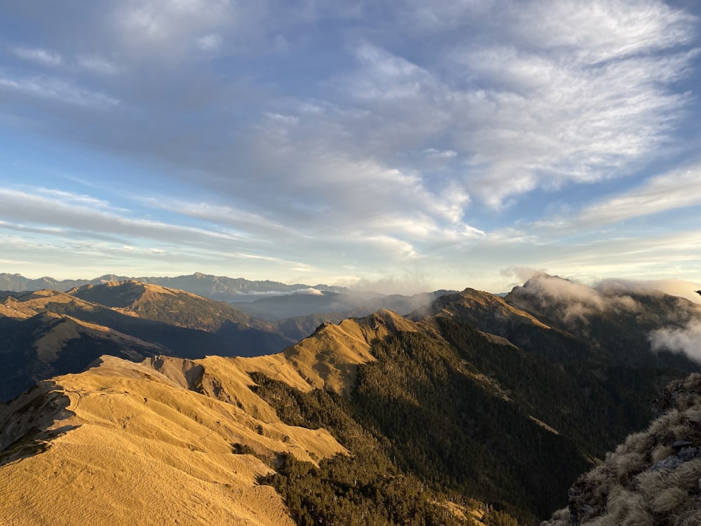 a view of a mountain range with clouds in the sky