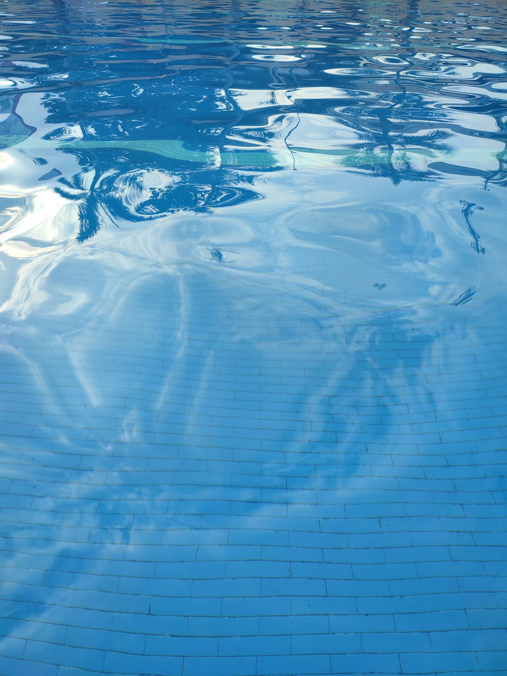 a swimming pool with a blue tile floor