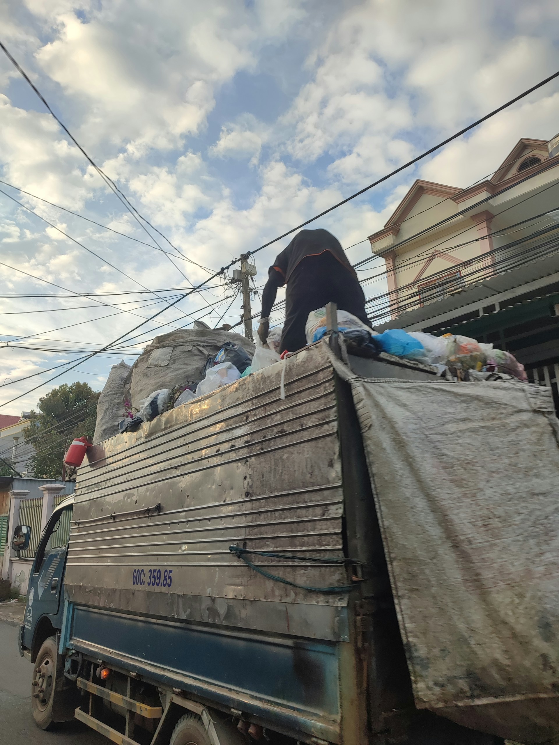 woman wearing yellow long-sleeved dress under white clouds and blue sky during daytime