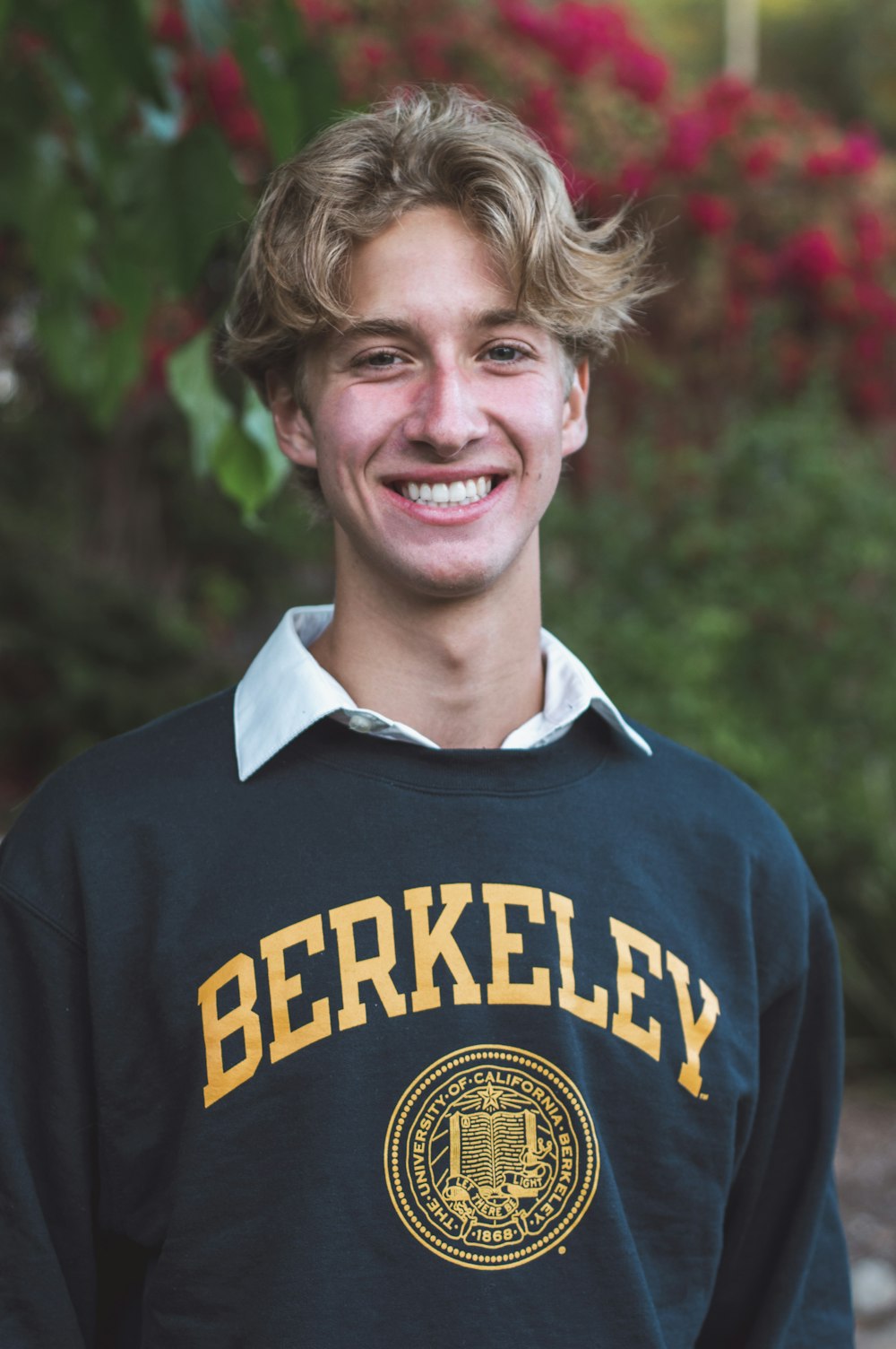a young man wearing a black and gold sweatshirt
