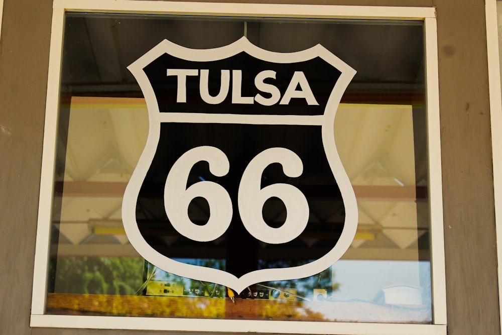 a close up of a street sign in a window