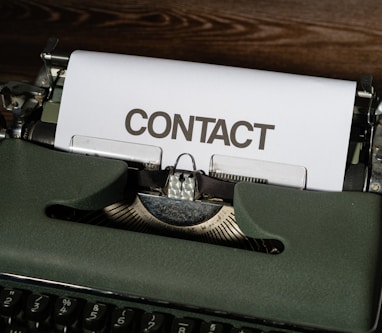 a close up of a typewriter with a contact paper on it