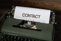 a close up of a typewriter with a contact paper on it