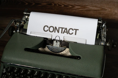 a close up of a typewriter with a contact paper on it