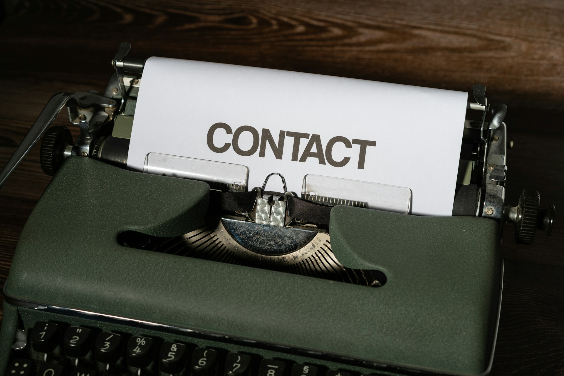 a close up of a typewriter with a contact paper on it