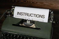 a close up of a typewriter with instructions on it
