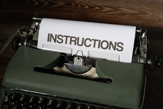 a close up of a typewriter with instructions on it