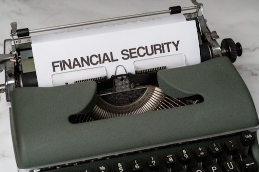 a close up of a typewriter with a financial security sign on it