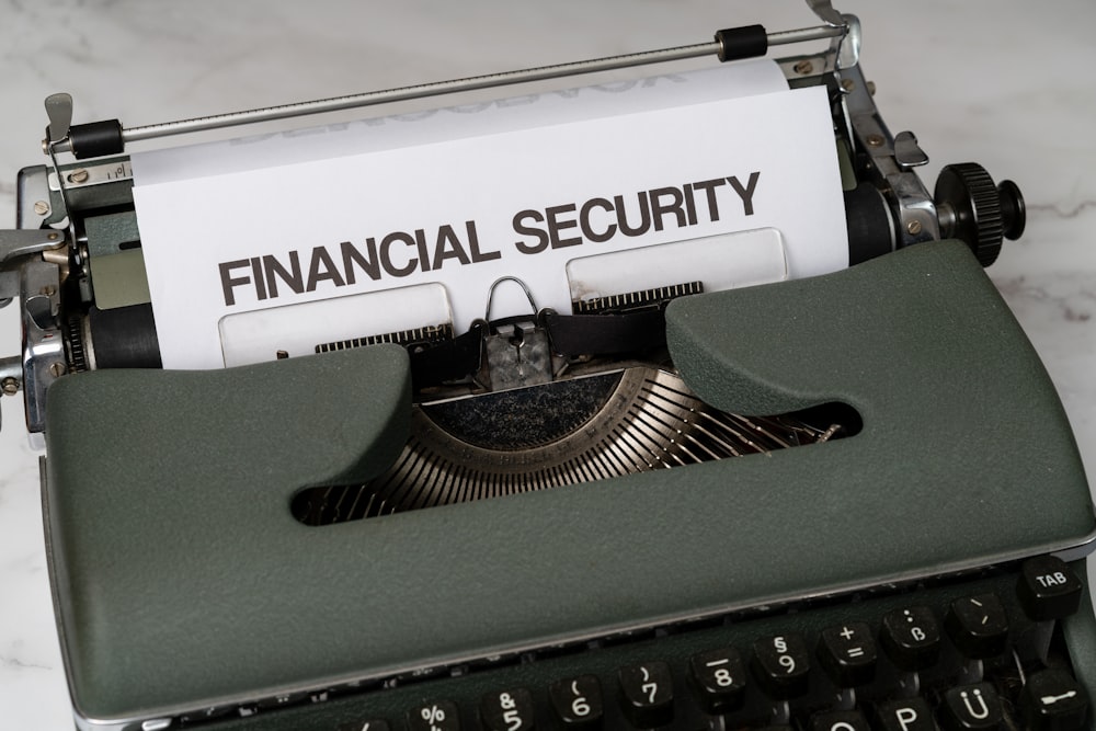 a close up of a typewriter with a financial security sign on it