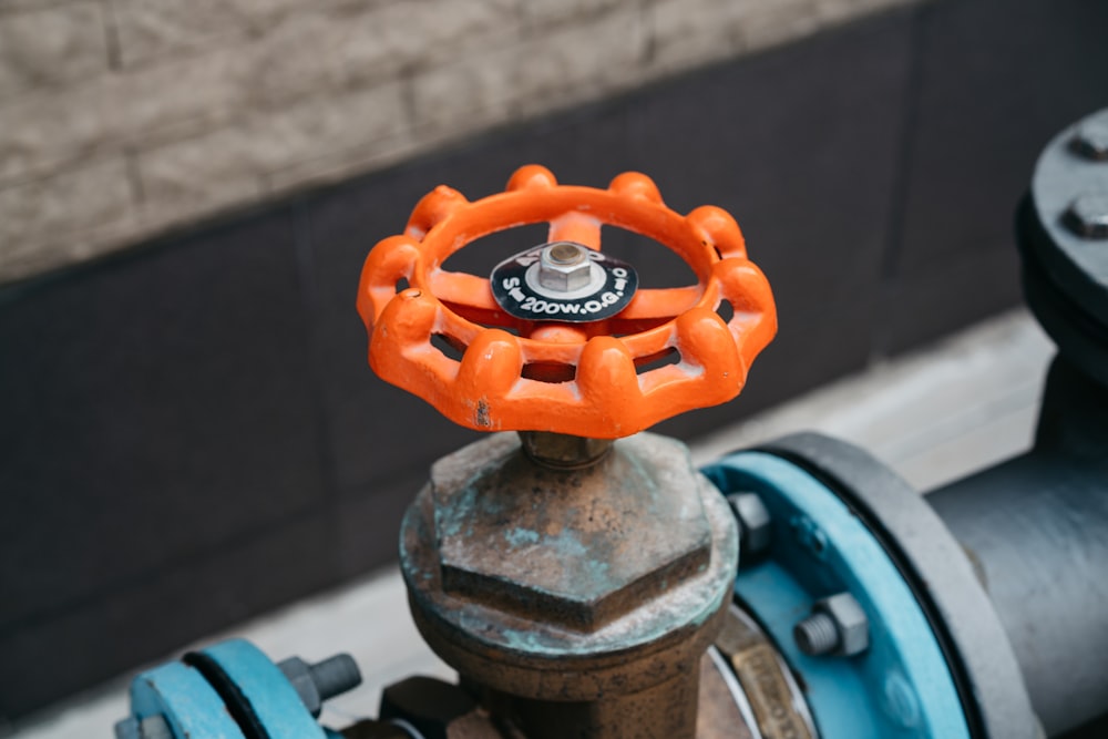 a close up of an orange and black fire hydrant
