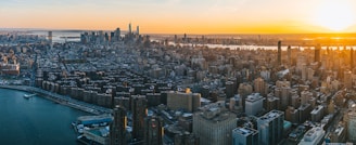 Aerial drone shot capturing a stunning cityscape at golden hour with smooth cinematic lighting.