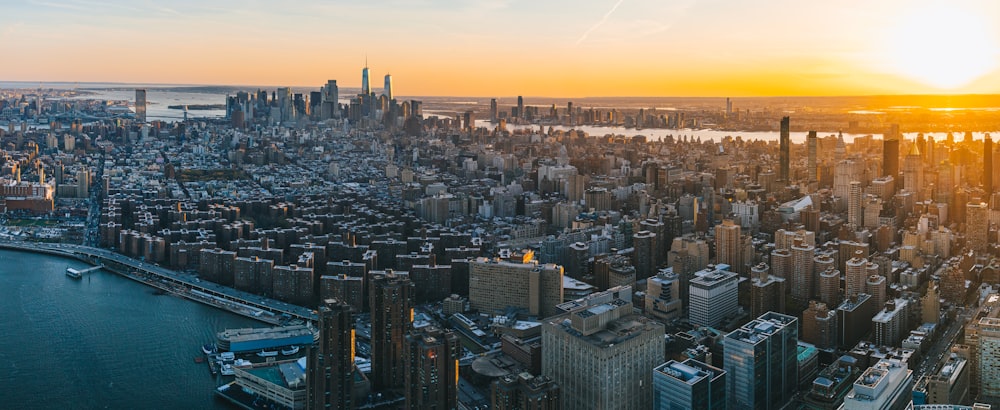 an aerial view of a city at sunset