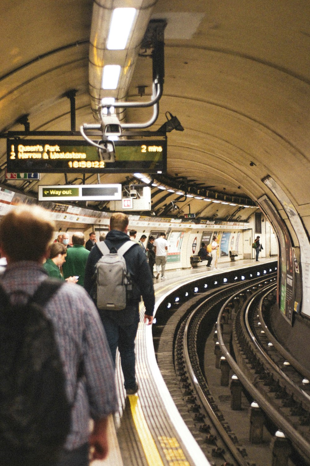 a group of people standing on a train platform