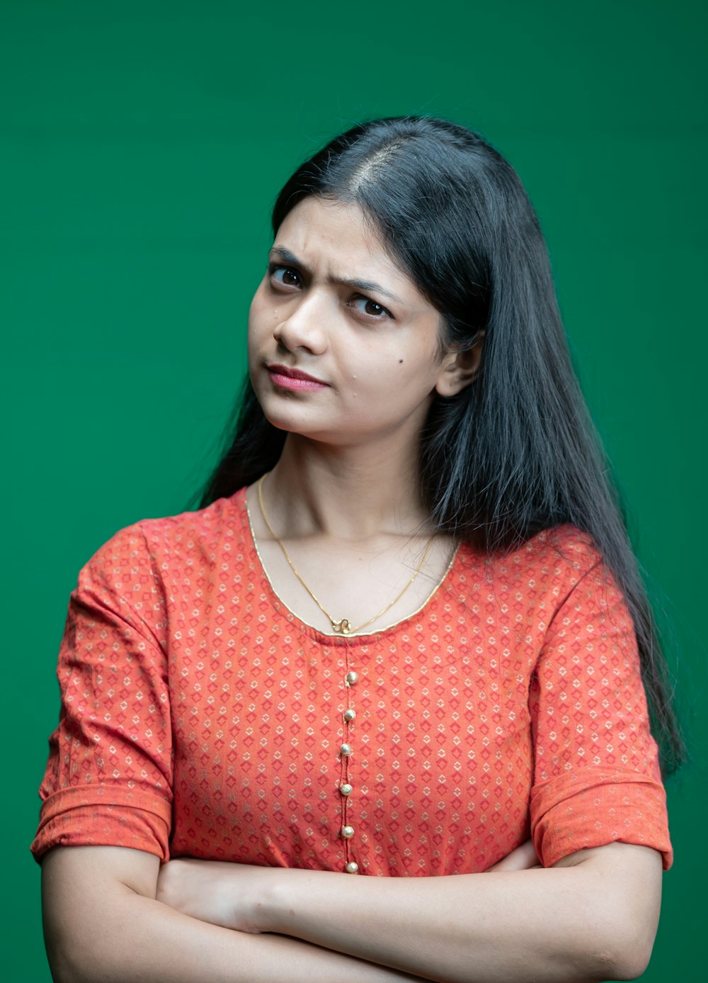 a woman standing with her arms crossed