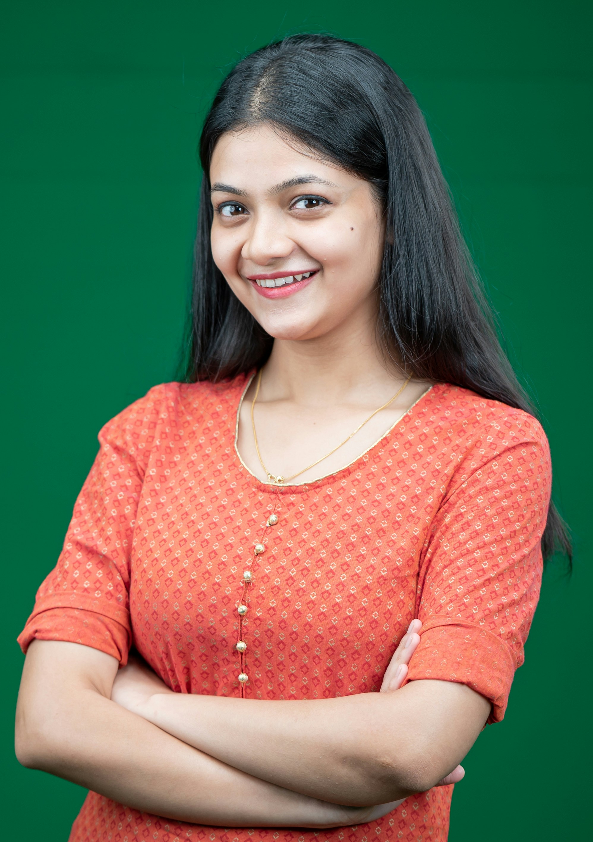 a woman with her arms crossed posing for a picture