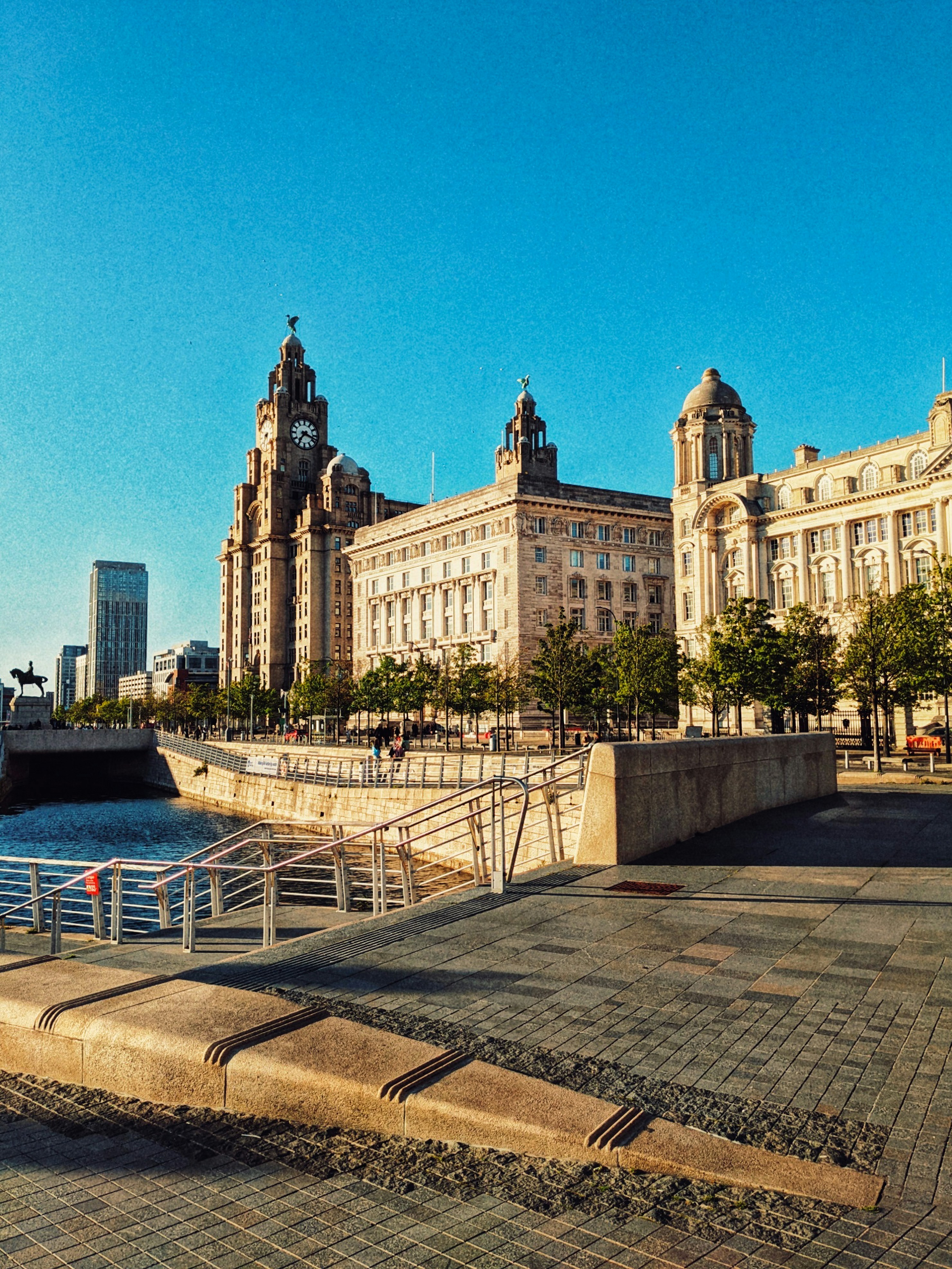 a large building sitting next to a body of water