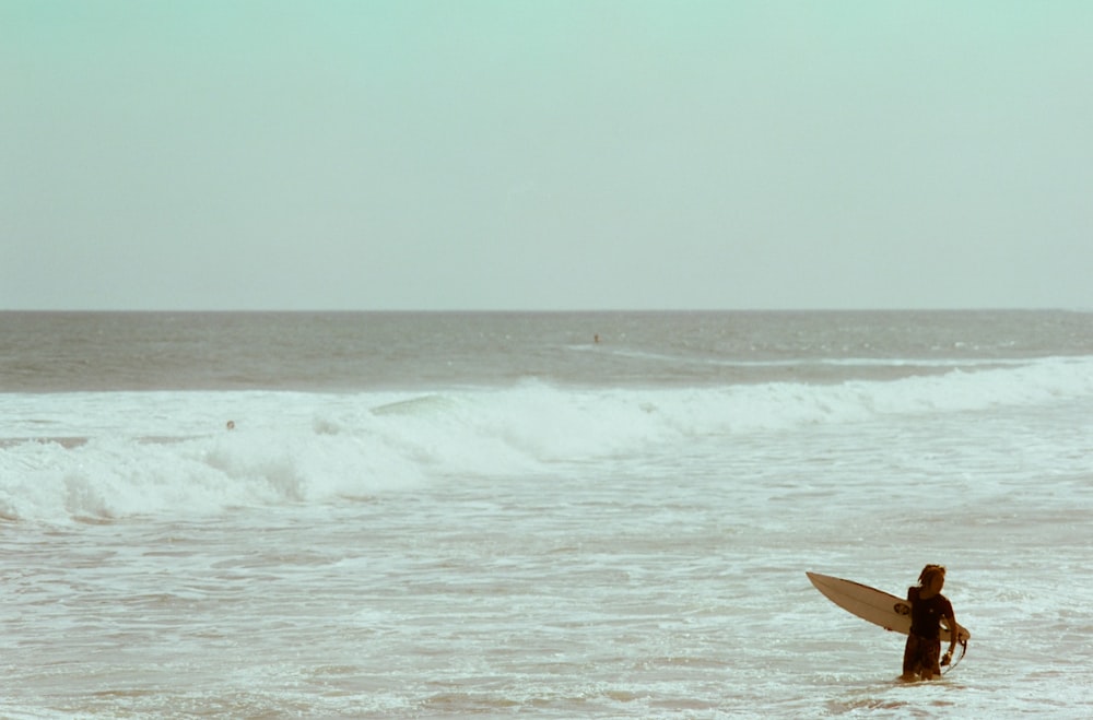 a person with a surfboard in the water