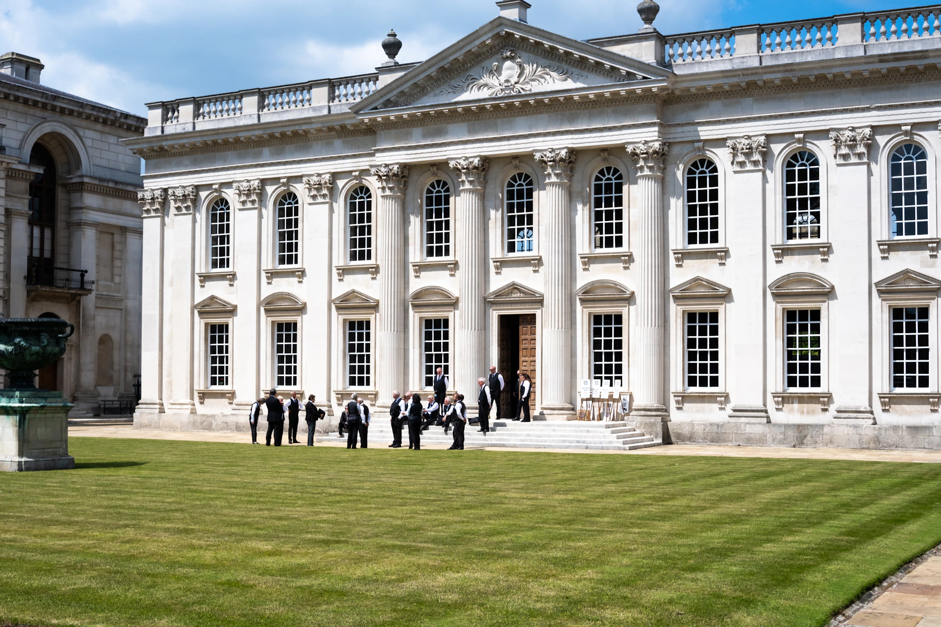 a group of people standing in front of a large building